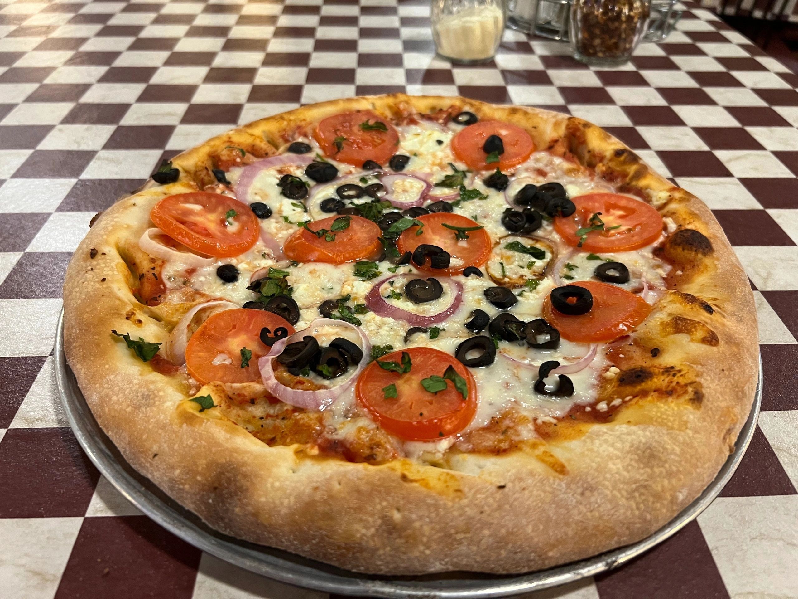 Fresh pizza with tomatoes and olives