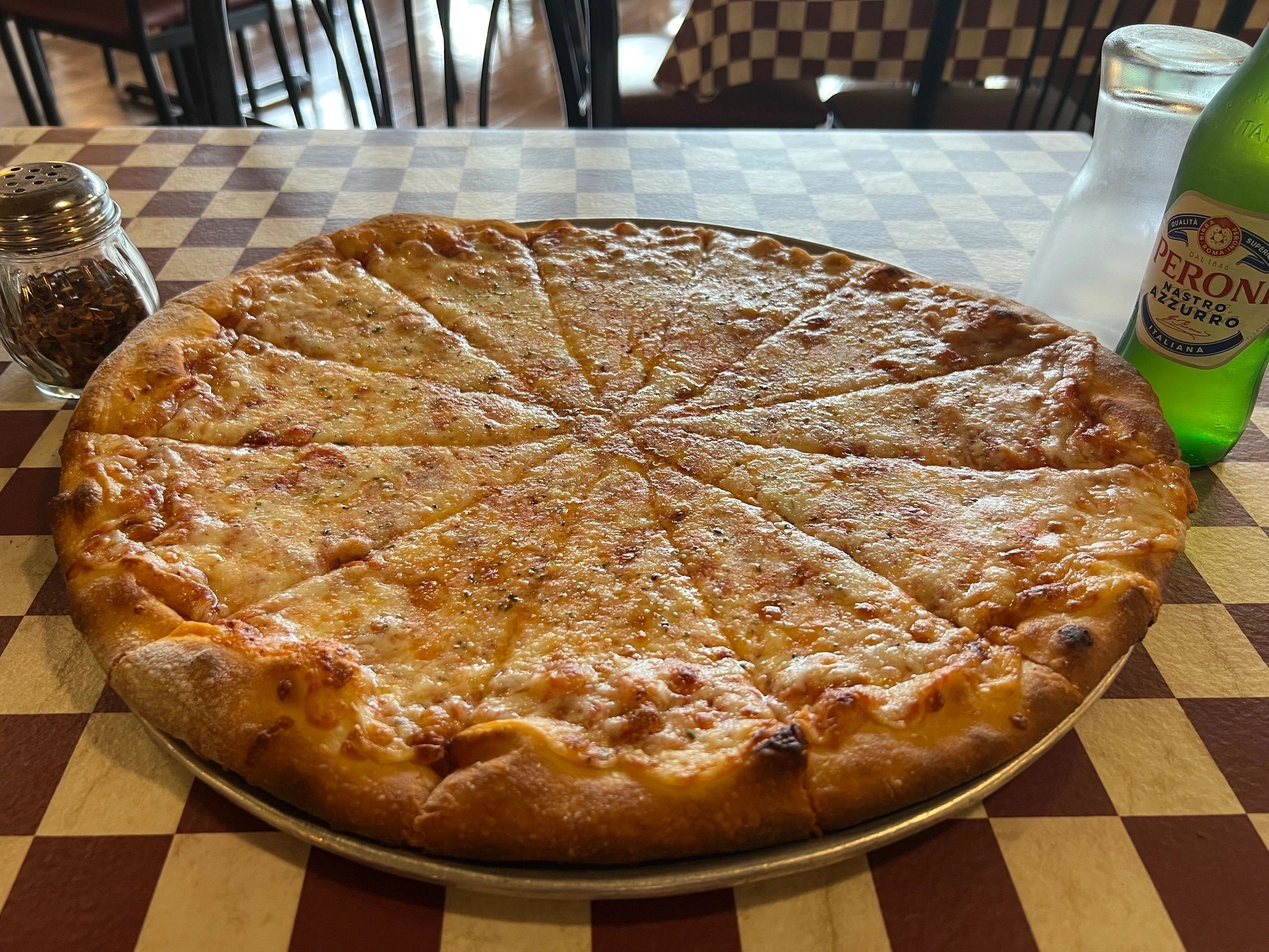 Pizza with Peroni beer at Village Pizza Restaurant