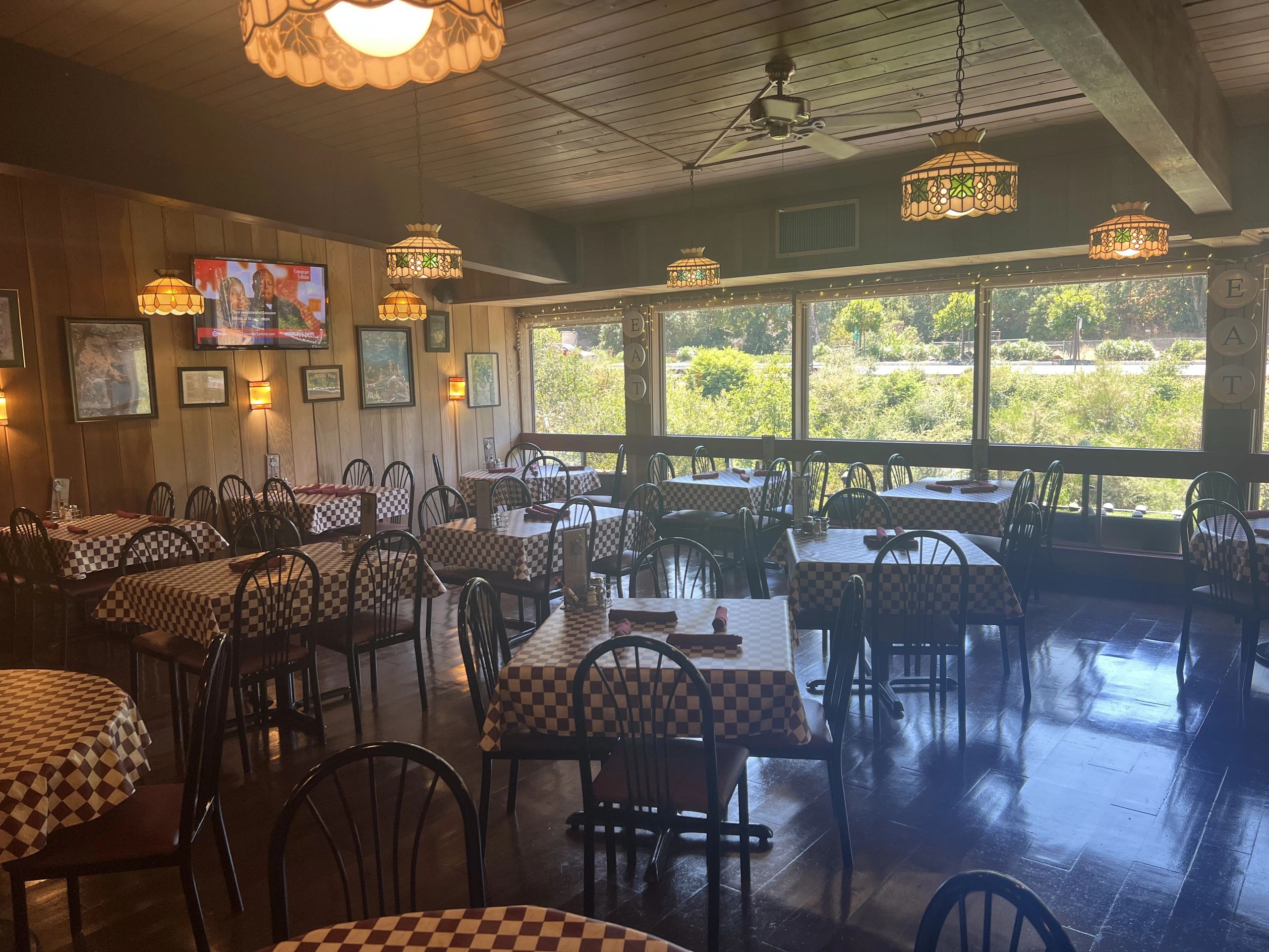 Village Pizza Restaurant interior with checkered tablecloths and warm lighting